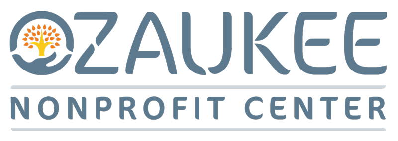 The image shows the logo for the Ozaukee Nonprofit Center, featuring stylized text and an emblem with a tree and hands.