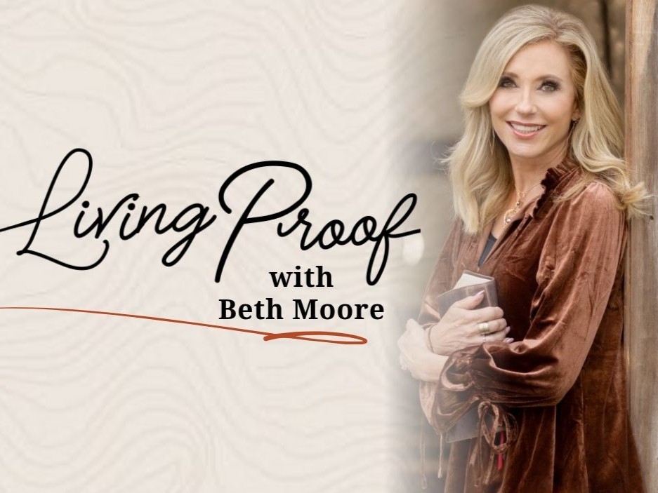 A person in a brown blouse holds a book beside text, "Living Proof with Beth Moore," against a textured background.